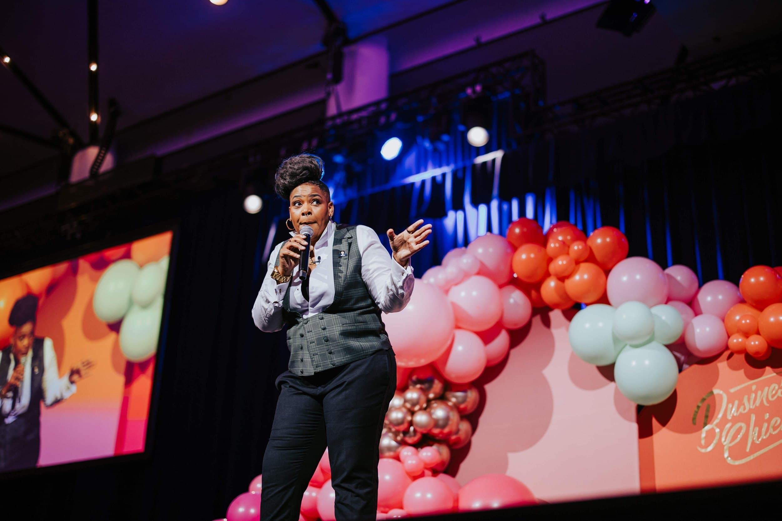 Azure Antoinette speaking on stage at a conference.
